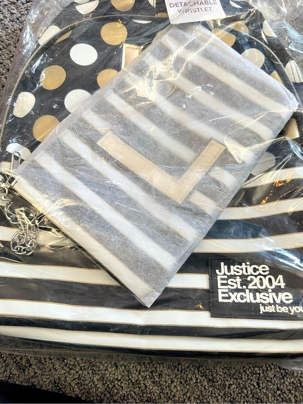 Justice Backpack with Detachable Wristlet. “L”
Black gold and white stripe and